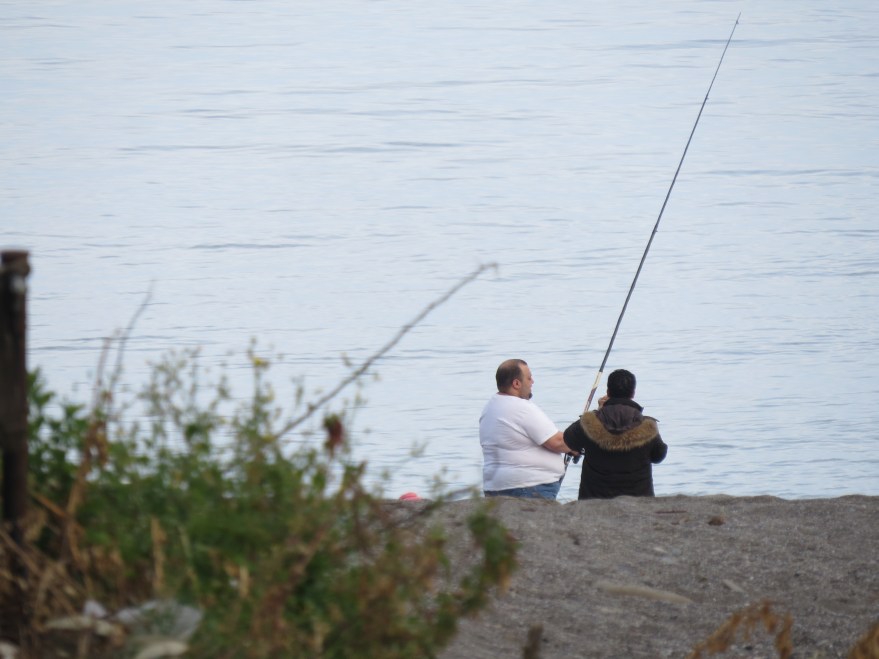 The man in the white t-shirt fishing is the chef or Mare Kambo, or Il Cuoco Grosse as the waiters told me.  The man in the dark shirt is the head waiter.